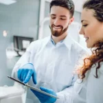 people-medicine-stomatology-health-care-concept-happy-male-dentist-showing-tablet-pc-computer-1024x683.jpg