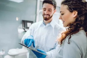 people-medicine-stomatology-health-care-concept-happy-male-dentist-showing-tablet-pc-computer-1024x683.jpg